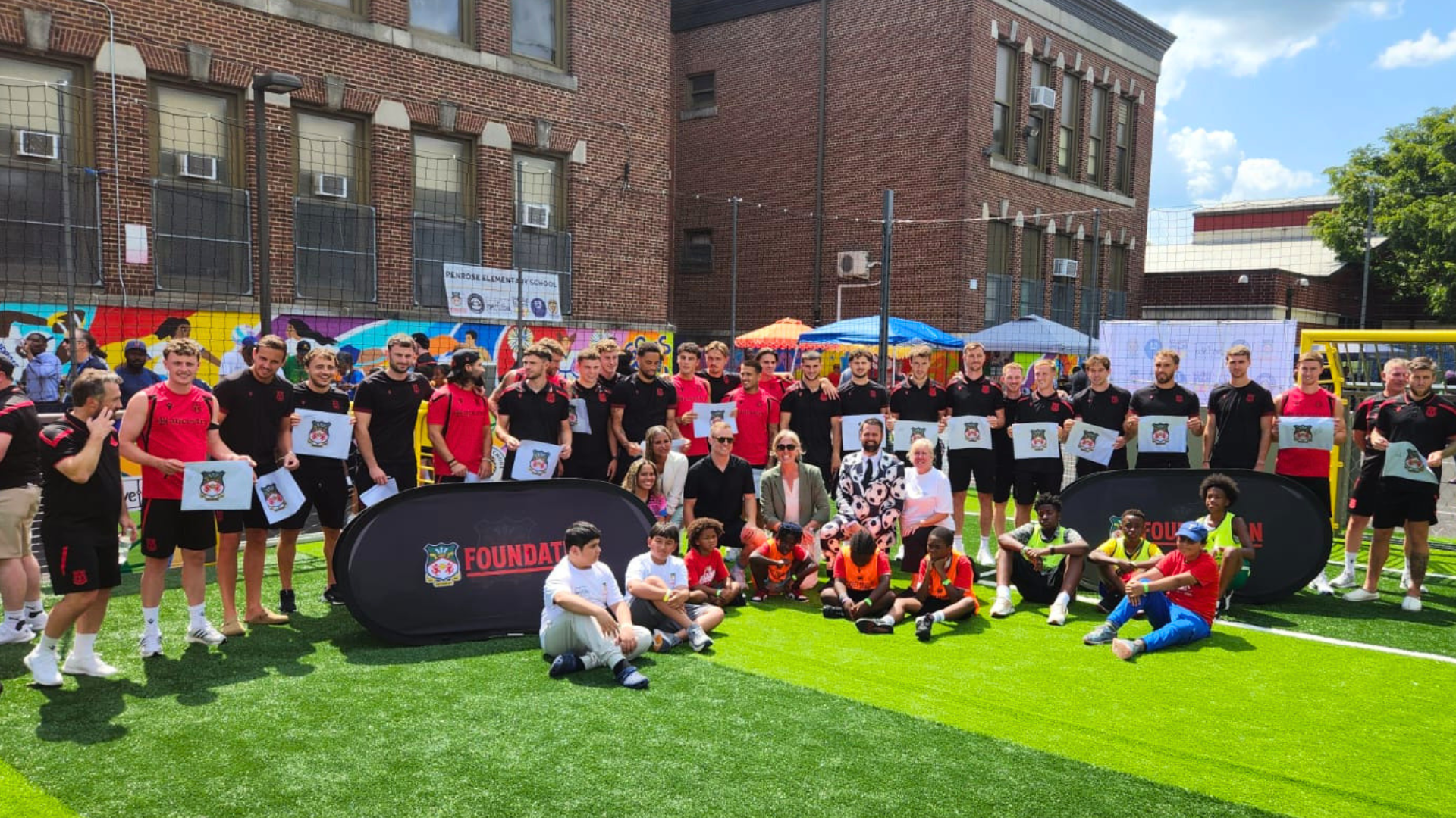 Wrexham AFC players joined the Penrose Elementary School community in Philadelphia to celebrate the inauguration of a new community-driven play space created with love.fútbol.