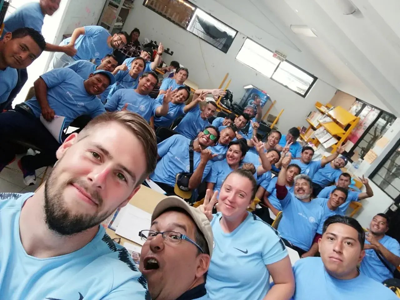 ManCity coaches, local volunteers, and Young Leaders Training attendees.